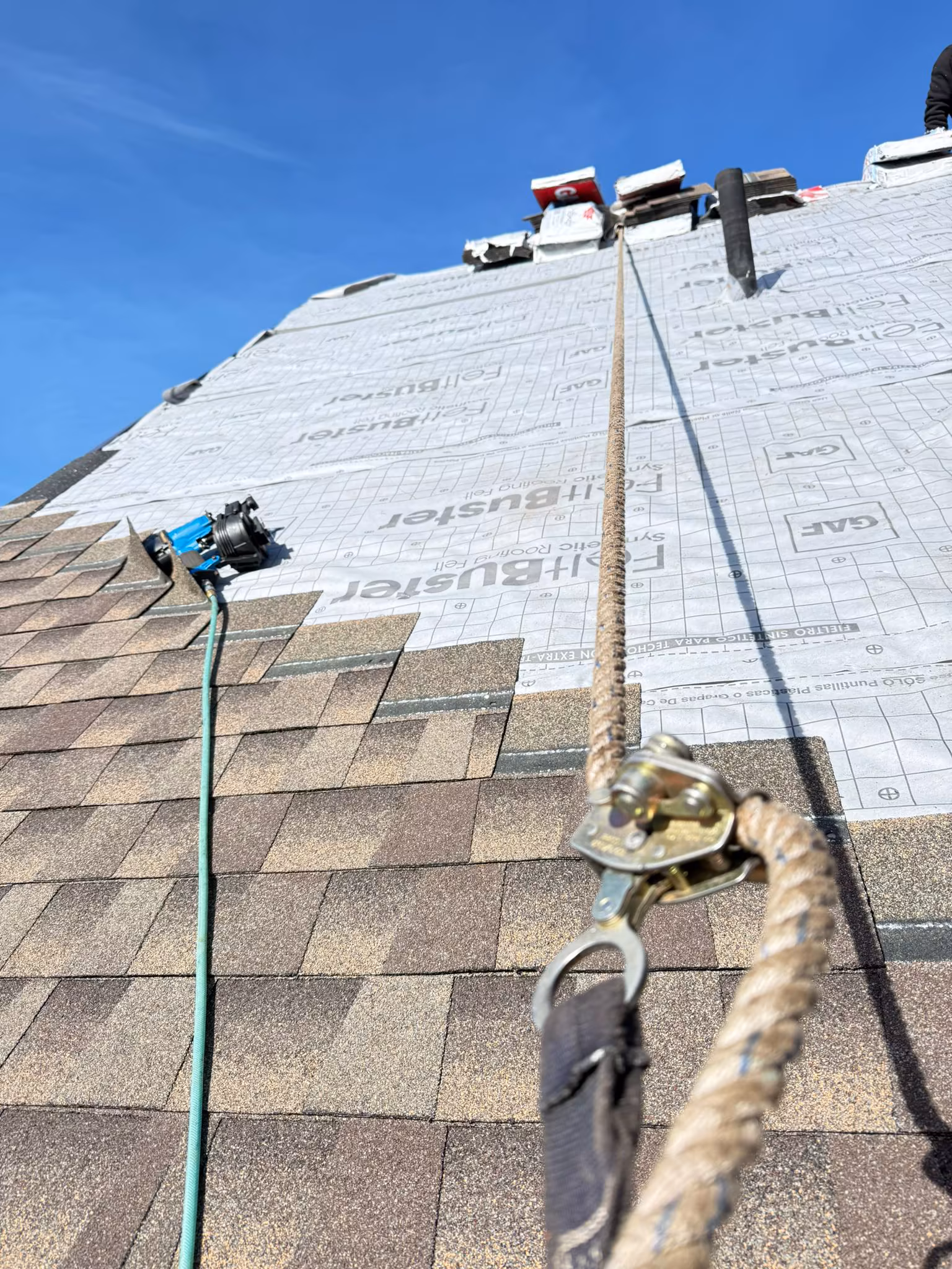 Completed asphalt shingle installation with GAF FeltBuster underlayment in Kelowna.